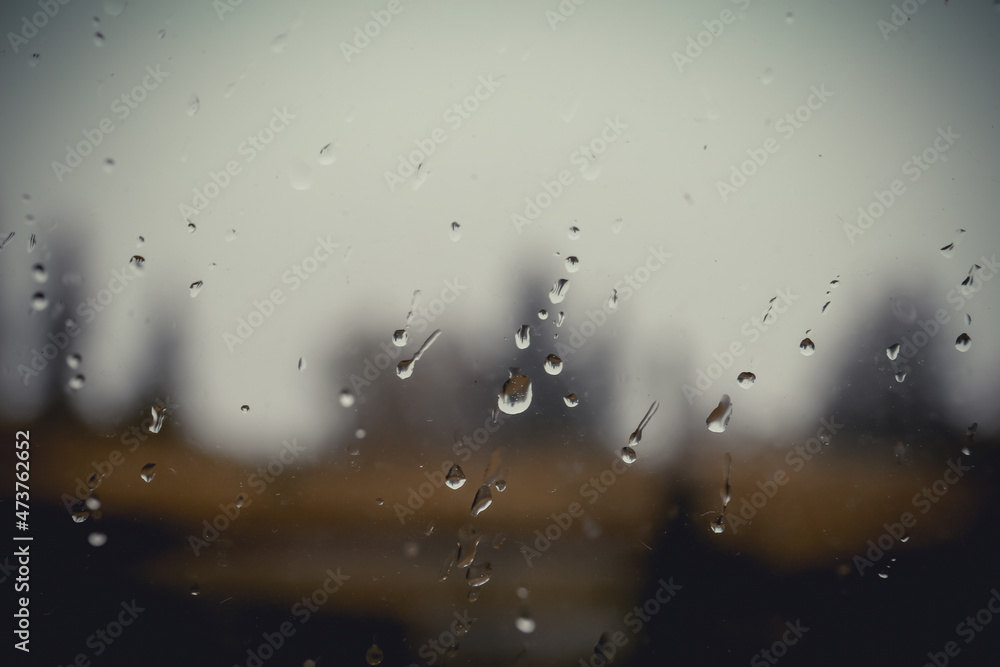 Blurred view through wet window on rainy day