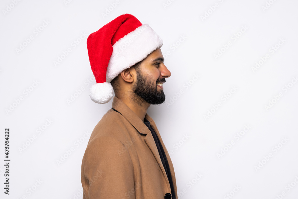 A young successful man with an Santa Claus hat isolated on white background A young successful man with an Santa Claus hat isolated on white background
