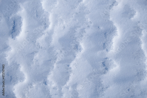 Texture of winter snow surface. Blue natural snow background.
