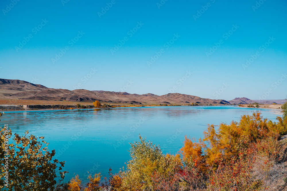 A beautiful autumn landscape of a blue river 