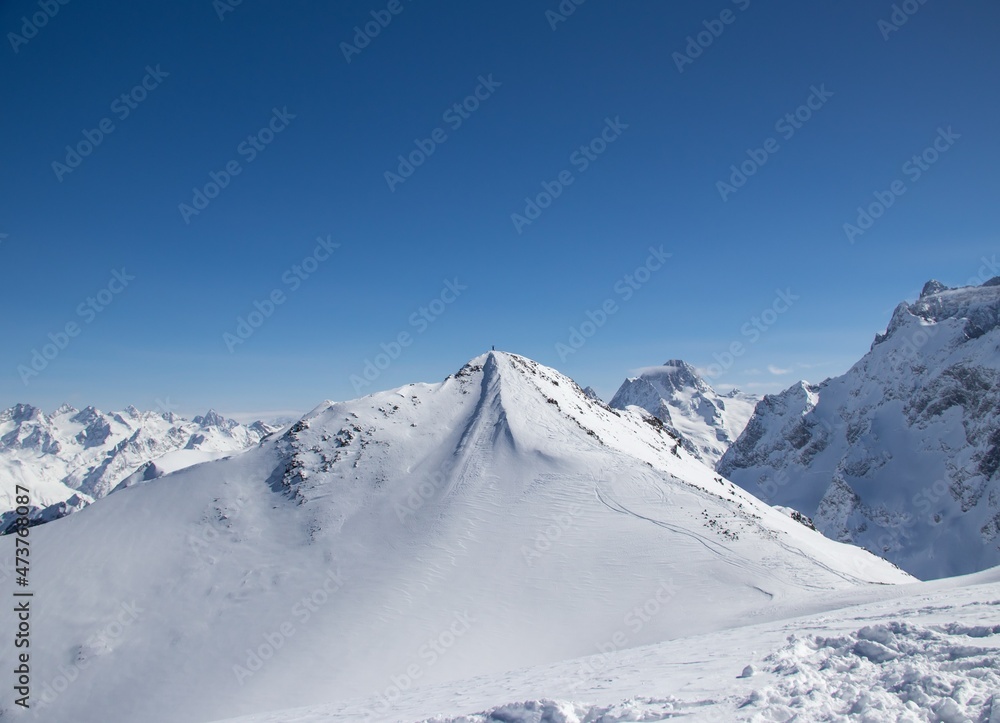 man with snowboard at the top of the snowy mountain