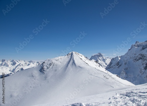 man with snowboard at the top of the snowy mountain