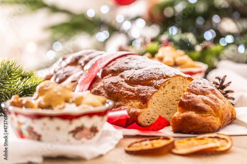 Traditional Czech Christmas cake Vanocka on a festive table in front of a Christmas tree photo