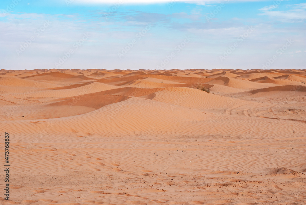 Desert sand dunes on distance in the Sahara in Tunisia. Desert sand dunes on distance in the Sahara in Tunisia.