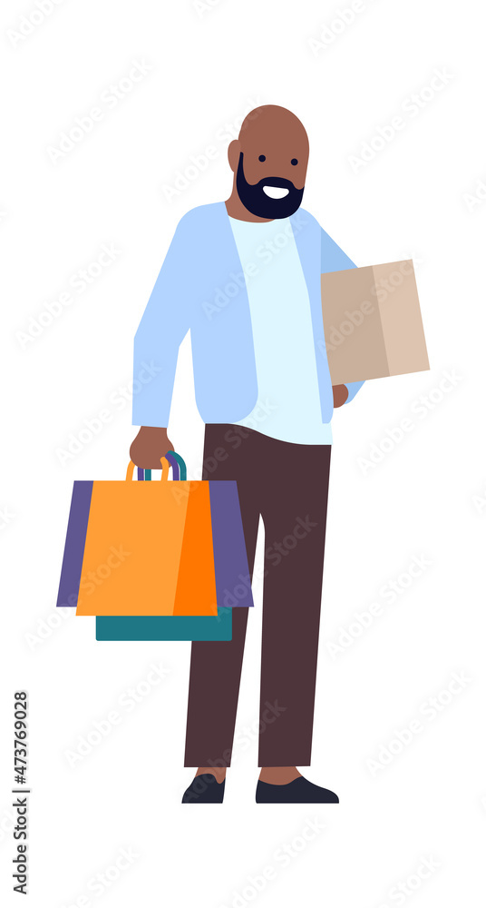 Man standing with paper bags and packages. Happy customer after shopping