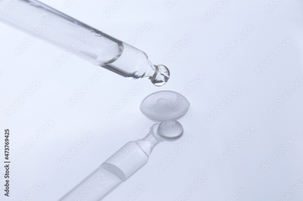 A drop of cosmetic oil and a dropper A drop of cosmetic oil and a dropper