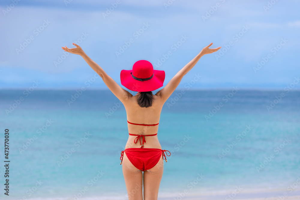 Young asian girl in bikini with hat standing on the beach summer vacation phuket thailand Young asian girl in bikini with hat standing on the beach summer vacation phuket thailand