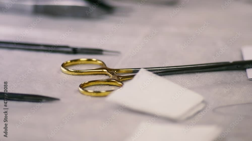 surgical instruments on the table in the operating room, gold scissors clamps. surgical instruments on the table in the operating room, gold scissors clamps.