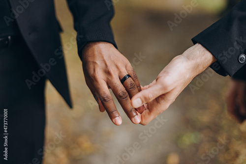 European Gay Couple holding hands, homosexual marriage wedding day. Gentle touch of a same sex couple © Dmitri