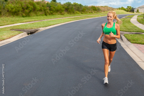 Beautiful Blond Woman Running and Listening to Headphones