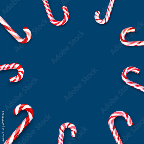 Red and white striped candy cane sticks frame on blue background.