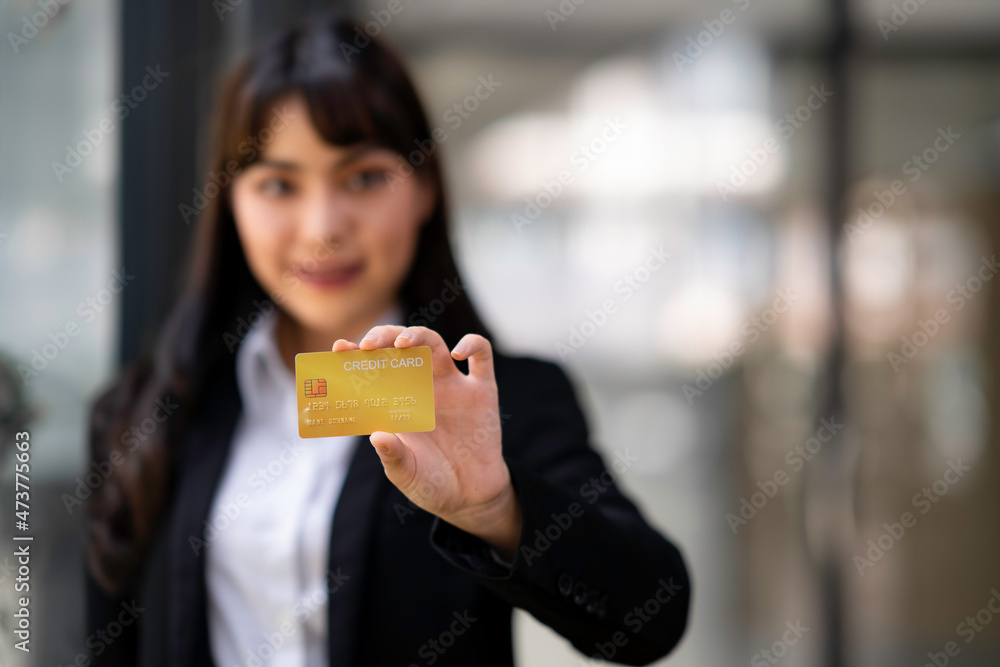Businesswoman holding credit card while using laptop computer to buy or pay online, online shopping. Businesswoman holding credit card while using laptop computer to buy or pay online, online shopping.