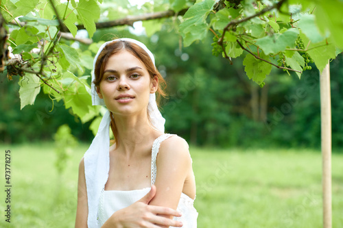 Woman in white dress in the village outdoors Green grass Farmer