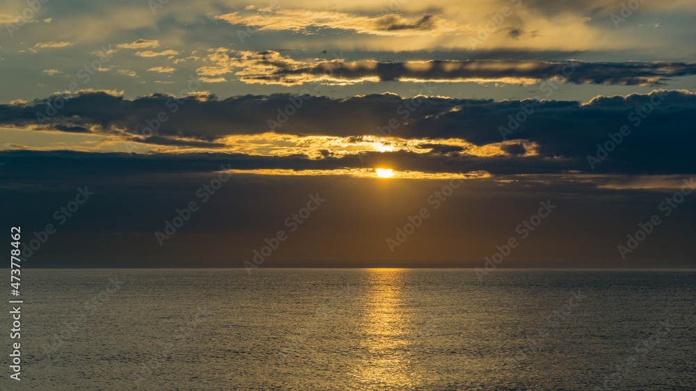 Obraz premium Beautiful sea landscape with sunset on the horizon. Sochi, Black Sea coast of south of Russia. Scenic sky with clouds over the golden water of Black sea. Luxury clouds and natural sky background