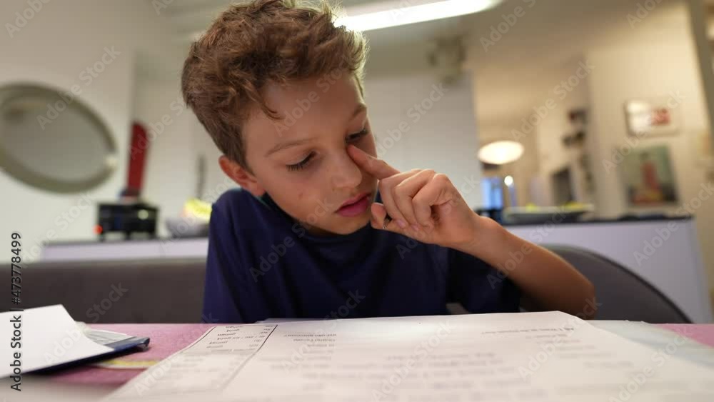 Young boy doing homework after school. Kid preparing for exam Young boy doing homework after school. Kid preparing for exam