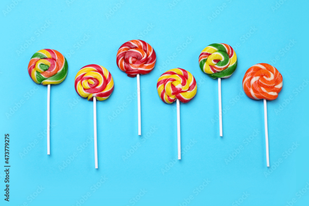 Sweet lollipops on light blue background, flat lay Sweet lollipops on light blue background, flat lay