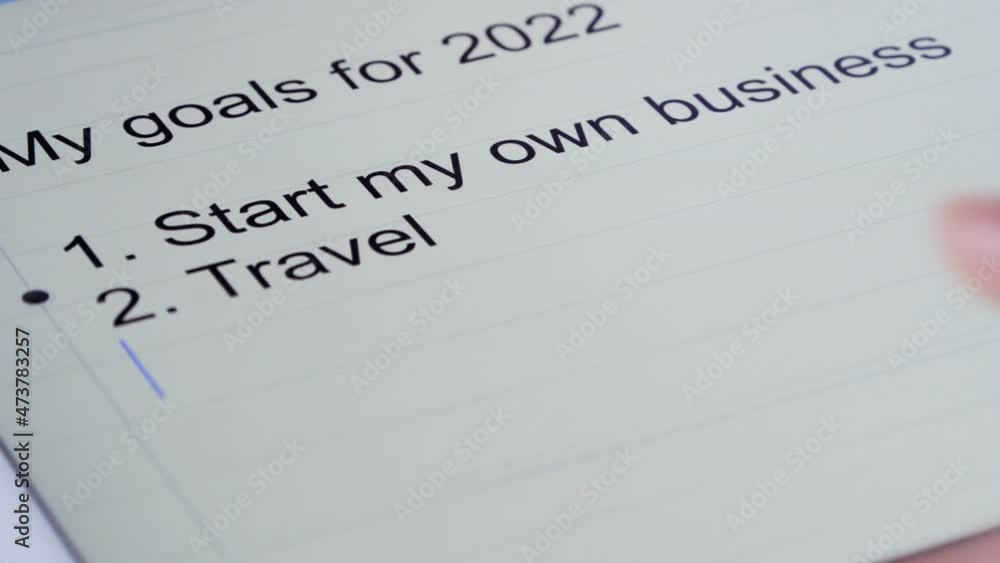 Writing down new year goals and resolutions on tablet. Personal vision for a better future, starting own business. Concept for new year action planning. Writing down new year goals and resolutions on tablet. Personal vision for a better future, starting own business. Concept for new year action planning.