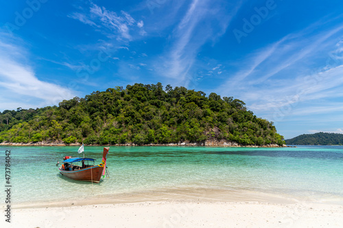 Beautiful Andaman sea, Tropical Turquoise clear blue sea and white sand beach with blue sky background at Lipe Island, Satun, Thailand - summer vacation travel
