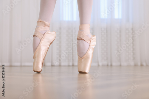 Little ballerina practicing dance moves in studio, closeup of legs. Space for text