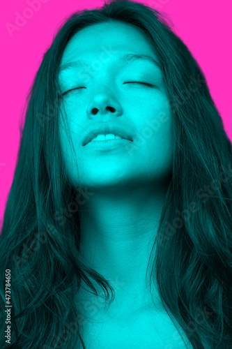 Artistic portrait of a happy woman on bright pink background
