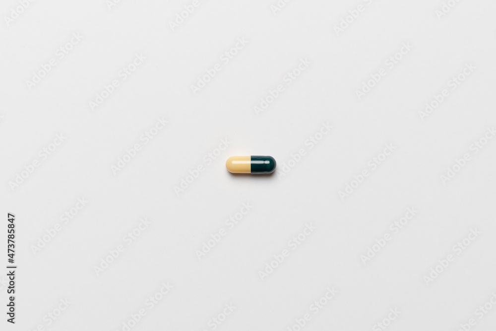 abstract single medicine pill on the colored surface, minimalistic style abstract single medicine pill on the colored surface, minimalistic style