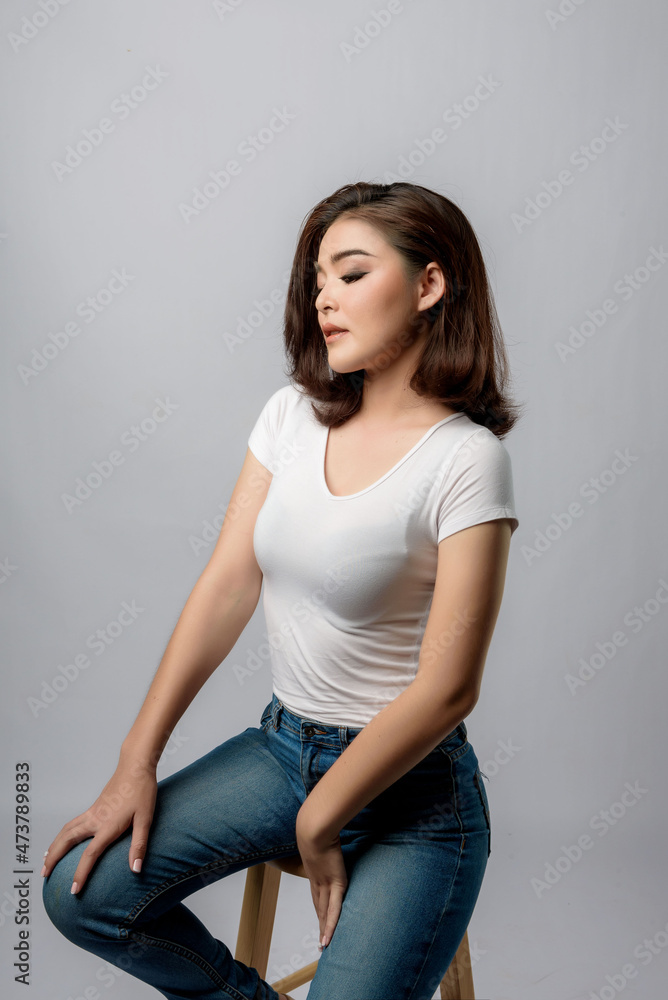 Beautiful female model . High fashion portrait sits in a light studio., isolated on white background. Beautiful female model . High fashion portrait sits in a light studio., isolated on white background.