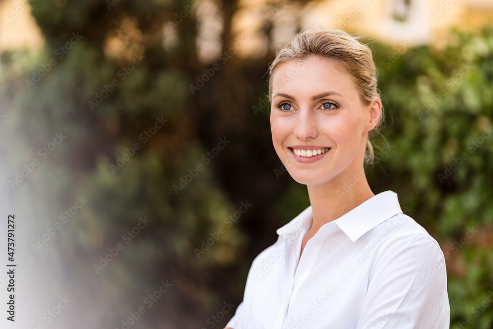 Smiling beautiful female professional with blond hair looking away Smiling beautiful female professional with blond hair looking away