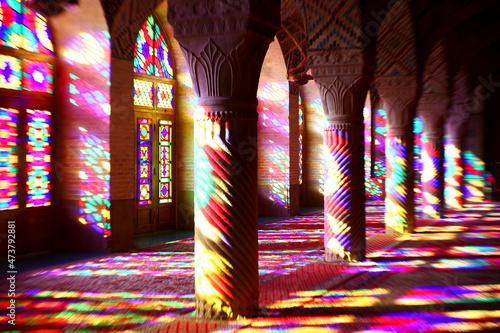 Iran, Fars Province, Shiraz, Sunlight illuminating interior of Nasir-ol-Molk Mosque through colorful stained glass windows photo