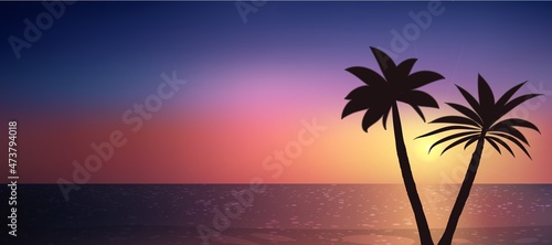 Silhouette of palm trees on a beautiful sunset over the ocean.