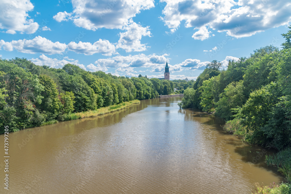 Fototapeta premium Aura river between trees at summer time in Finland.