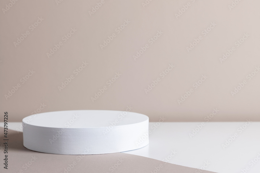 White round pedestal podium mockup on beige background. White round pedestal podium mockup on beige background.