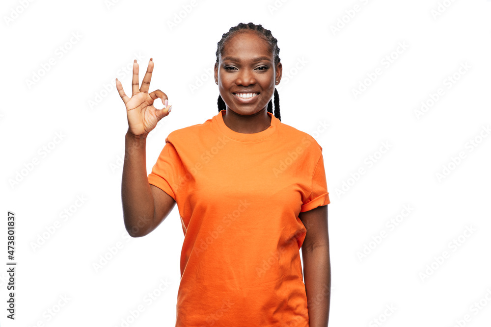 people, gesture and portrait concept - happy young woman showing ok hand sign over white background people, gesture and portrait concept - happy young woman showing ok hand sign over white background