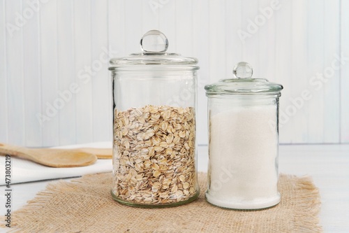 Stampa su tela Two pantry jars with oats and white sugar, glass jars mockup for food sticker or label presentation