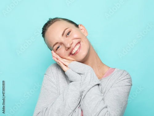 Pretty smiling female with blond hair, dressed casually, looking with satisfaction at camera, being happy.