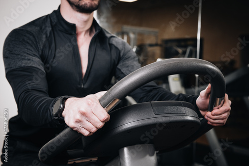 Fitness instructor on a stationary bike in a gym © Fabio Balbi