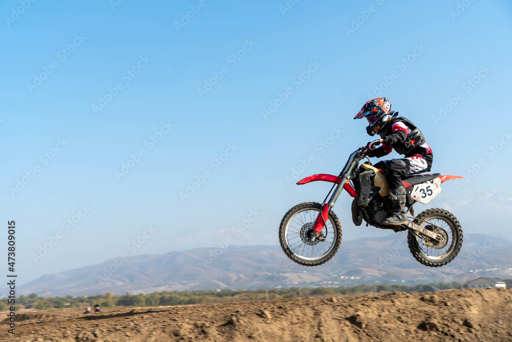 jumping on a motorcycle. motocross. motorcycle racing. bikers on the track jumping on a motorcycle. motocross. motorcycle racing. bikers on the track