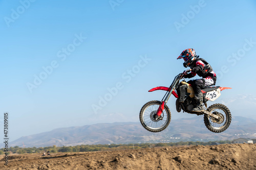 jumping on a motorcycle. motocross. motorcycle racing. bikers on the track © denis