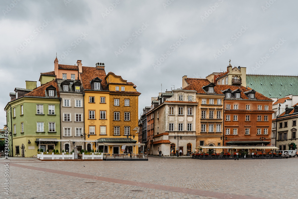 Empty Castle Square in Warsaw,capital of Poland.Historic downtown with colorful Renaissance and Baroque merchants houses.Town panorama on cloudy day.Travel urban concept.No tourists in city centre