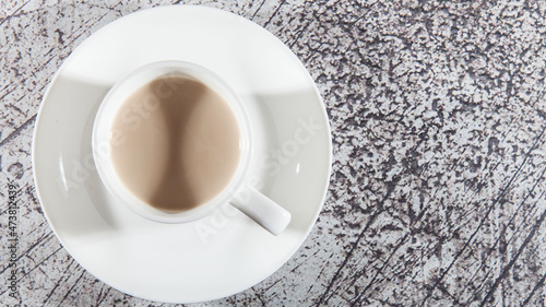 A mug of coffee on a glass saucer