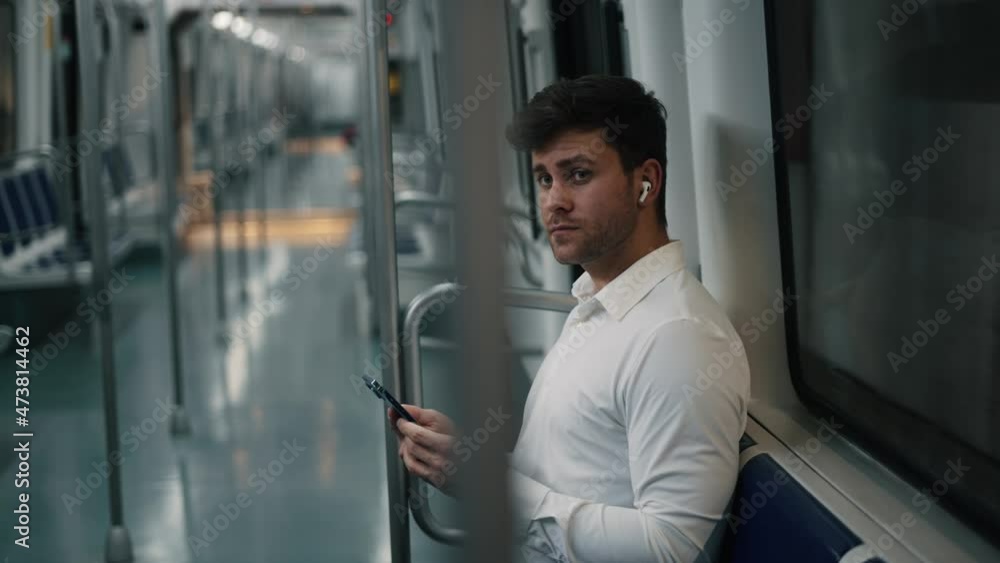 Businessman with smartphone arriving on station Businessman with smartphone arriving on station
