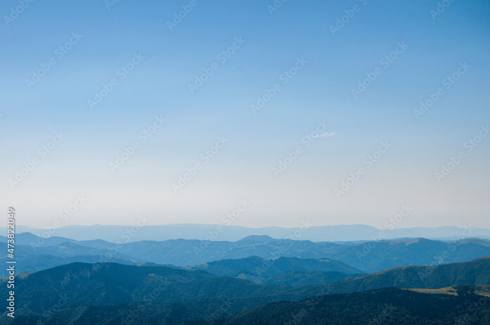 silhouettes of mountain peaks in the morning blue fog, beautiful landscape, travel. High quality photo