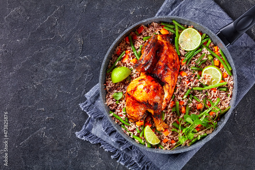 Roasted Half Chicken with brown rice in a skillet