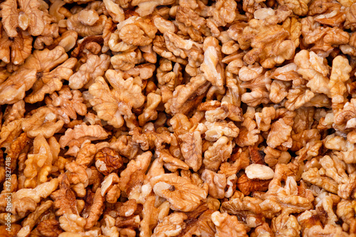 Raw walnuts outside of shell pile background pattern