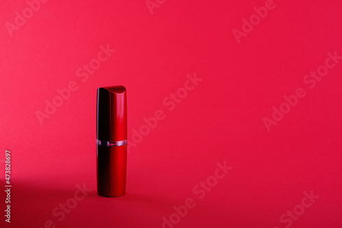 Red lipstick with a gold border on a red background