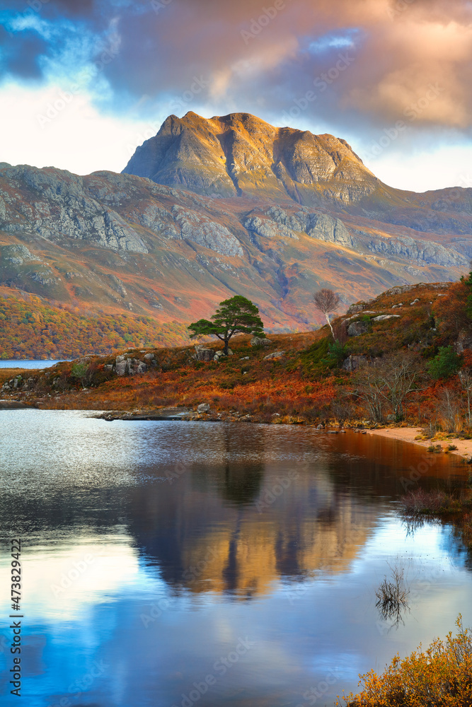 Slioch towering over Loch Maree on a Autumn afternoon. Wester Ross, North West Highlands, Scotland, UK.