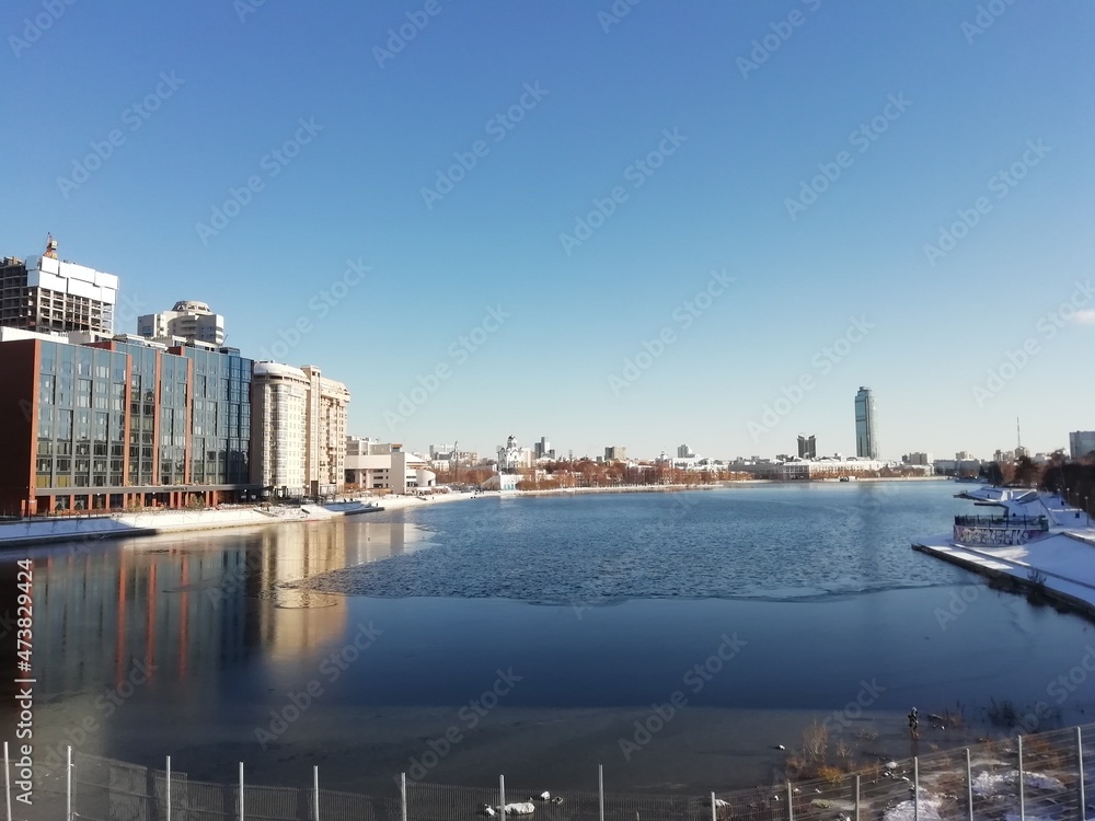Yekaterinburg, Russia - November 01 2021: View of buildings in Yekaterinburg city at the center. Iset river at winter time in sunny day