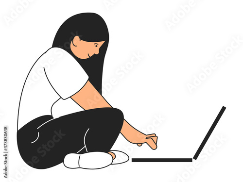 Young woman sitting on floor with laptop. Girl working on computer