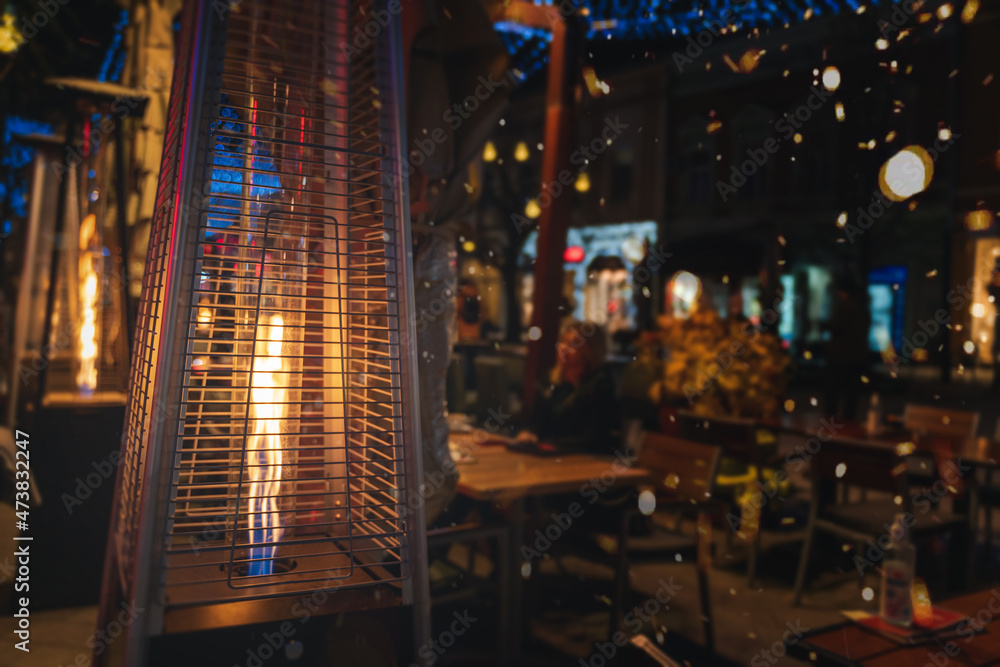 Street gas heater in street cafes in European city at night, lifestyle landscape and background