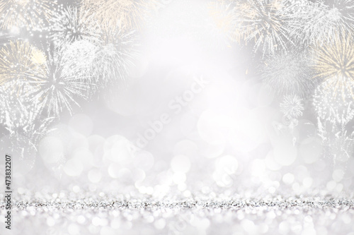 Silver fireworks and bokeh in New Year eve, copy space. Abstract background holiday