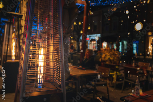 Street gas heater in street cafes in European city at night, lifestyle landscape and background
